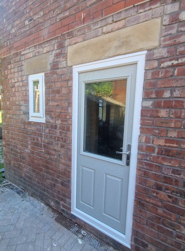 New composite rear door set under a stone lintel