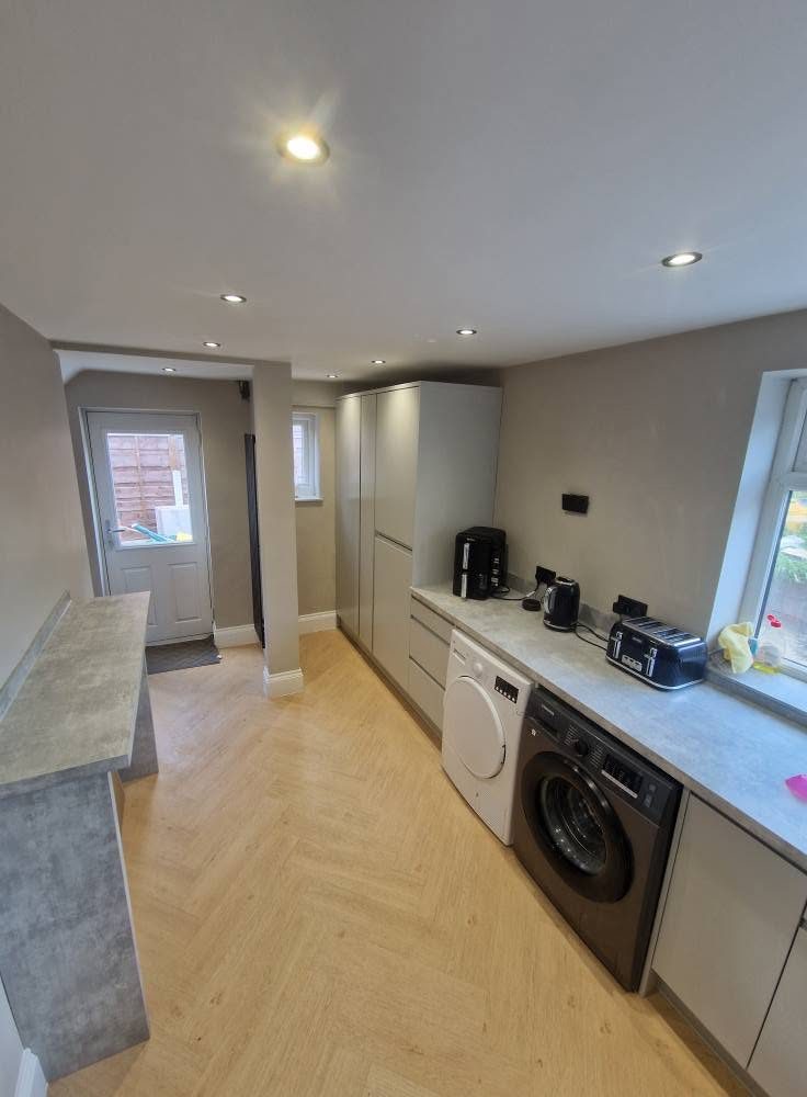 The utility end of the new kitchen with the washer and dryer housed
