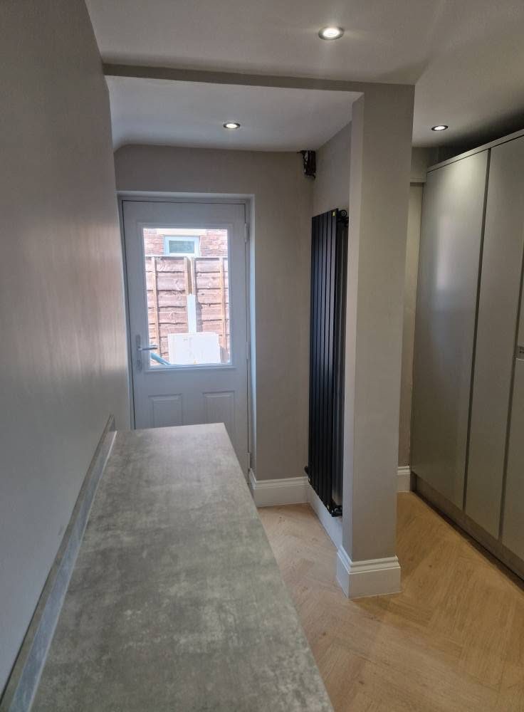 New vertical radiator and herringbone flooring in the hallway